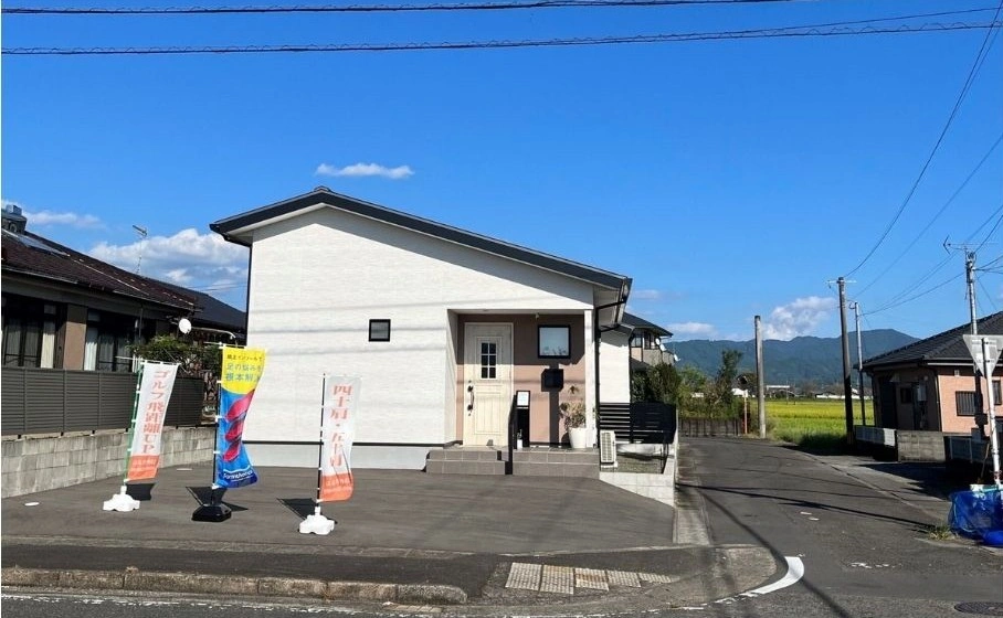 はる整体院の外観と駐車場。白い平屋の建物の前に「四十肩・五十肩」「ゴルフ飛距離UP」「インソール」ののぼり旗が立っており、アクセスを示している写真